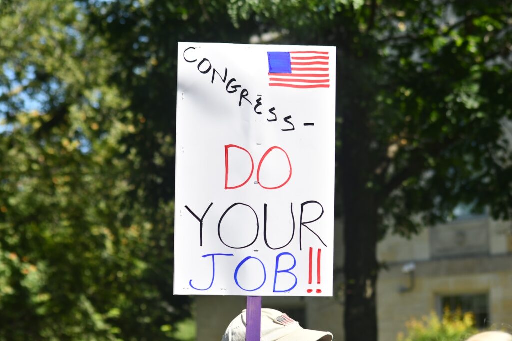 Protest sign reads congress do your job.