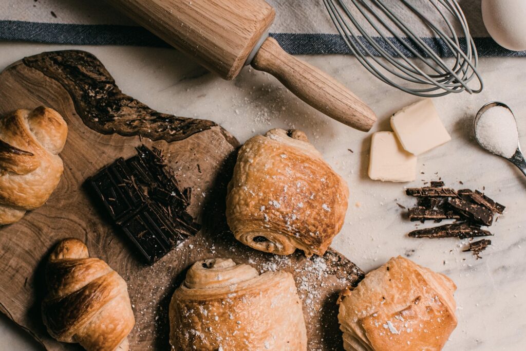 brown wooden rolling pin beside brown wooden rolling pin